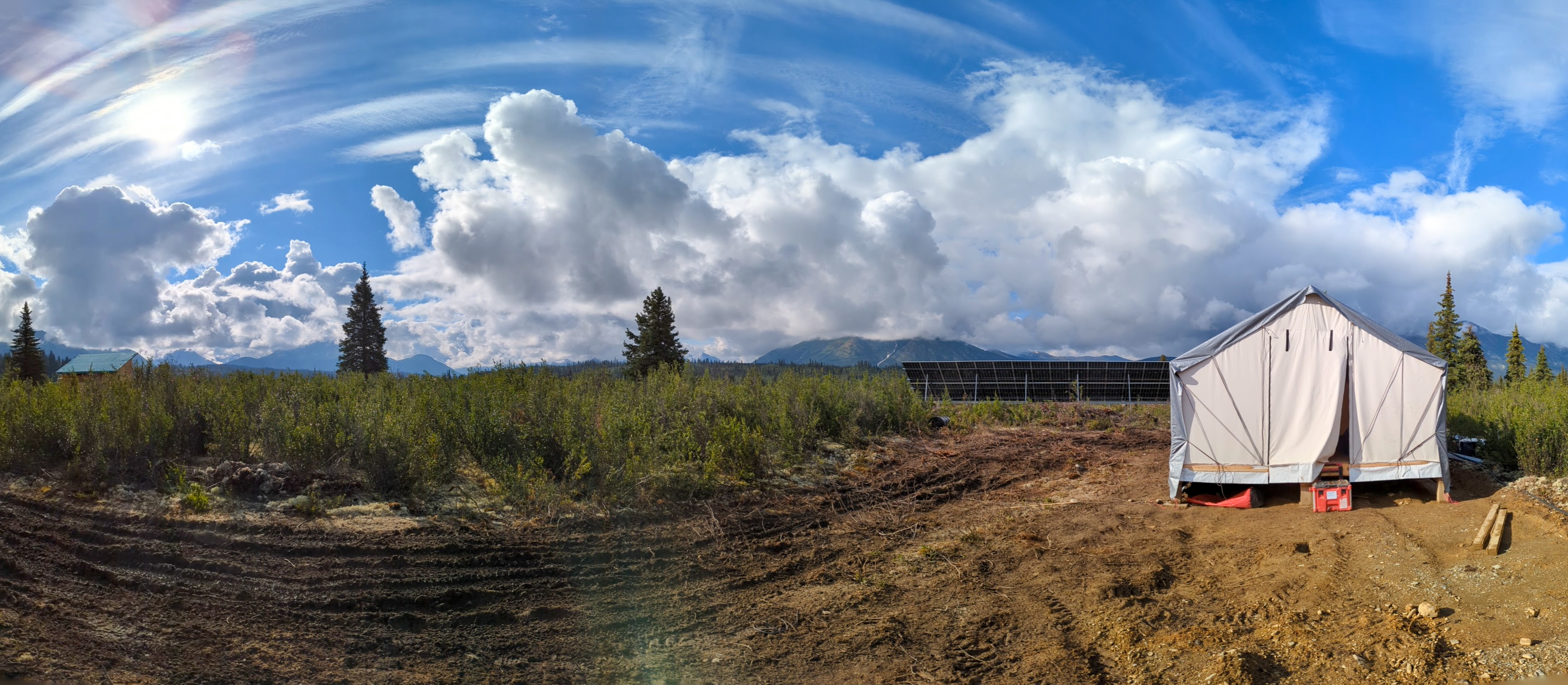 Images of the ground solar array and battery bank system in a wall tent at the Snowline Gold Exploration Camp. A helicopter delivers the modular, mobile system.